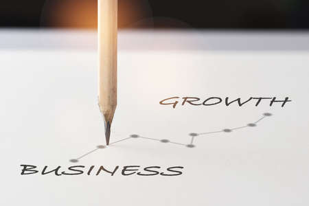 Business growth graph written on white paper with pencil. Sustainable future planning improvement concept and business success ideaの写真素材