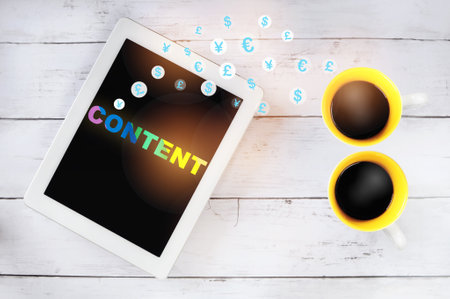 Digital marketing content with currency symbol on computer tablet with cups of coffee on table. Lgbtq concept and equality ideaの写真素材