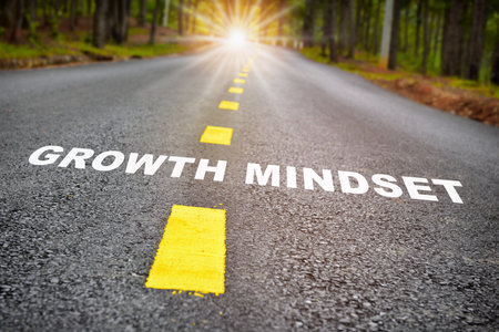 Growth mindset with sunbeam on road surface. Journey to self development to success concept and challenge ideaの写真素材
