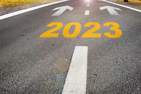 Year 2023 with arrow sign marking on road surface for future ahead. Business challenge concept and recovery ideaの写真素材