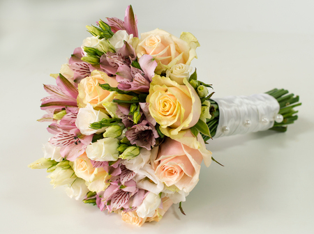 Bridal bouquet of roses and alstroemeria isolated on whiteの写真素材