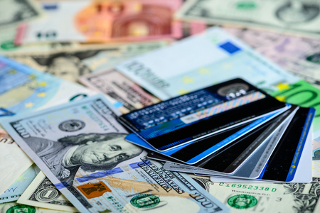 Dollar vs euro banknotes and credit cards as background. Concept of payment and creditの写真素材