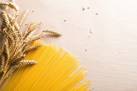 Italian food. Still life with spaghetti pasta and ears of wheatの写真素材