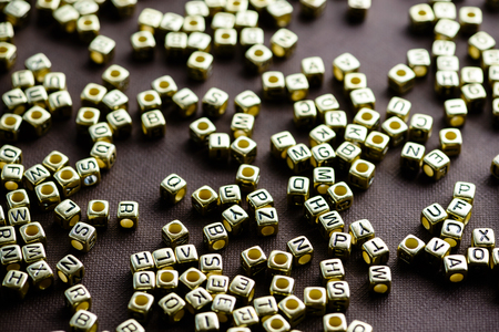 Golden letters was scattered on the table, selective focusの写真素材