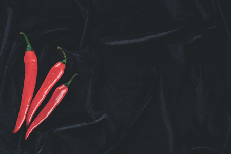 Red hot chili peppers on dark background. Top view, flat lay with copyspace for text, toned imageの写真素材