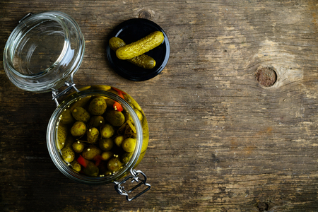 Glass jar with fresh low-salt pickled homemade cucumbers on woodの写真素材