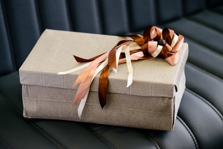 Holiday decor concept. Handmade gift box wrapped with paper andの写真素材