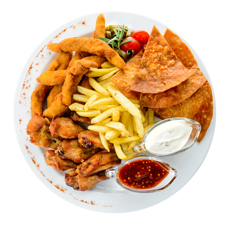 Set with different snacks and sauces in a white plate isolated oの写真素材