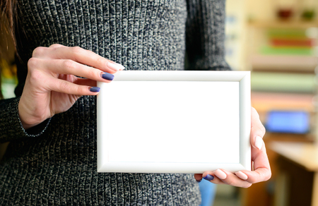 White mock up frame in woman handsの写真素材