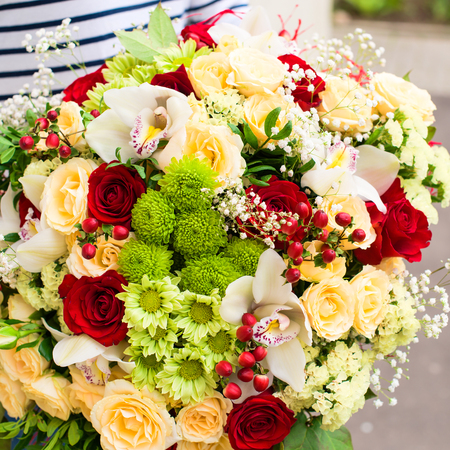 woman received a beautiful bouquet of red and beige roses, chrysの写真素材