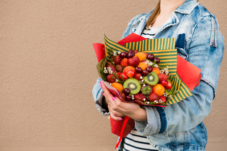 woman holding fruit bouquetの写真素材