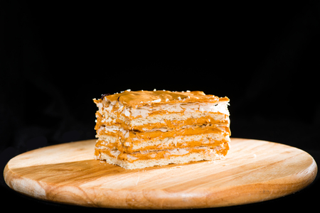 close-up delicious cake of puff pastry with sour cream on a woodの写真素材