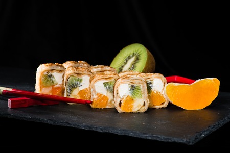 new trend in the Japanese cuisiune. Sweet sushi rolls in pancakeの写真素材