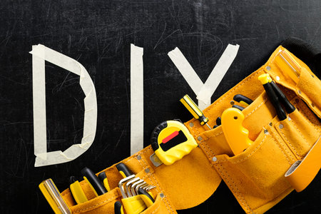 top view close-up of tool belt with construction tools and word