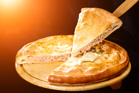 piece of tasty pie, round homemade delicious fish pie on woodenの写真素材