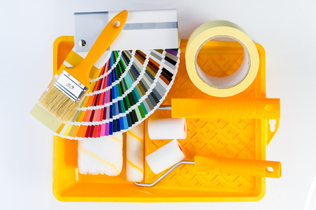 Color samples catalog, brush, paint tray, adhesive tape and painの写真素材
