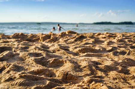 Beach scenery. Selective focus on sand beach, on the backgroundの写真素材