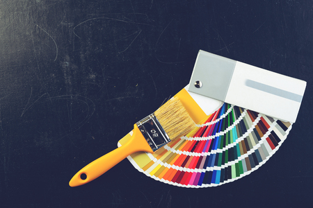 Paintbrush and colorful paint samples on dark background, tonedの写真素材