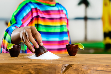 Mexican gold tequila. Selective focus on salt on the table, on tの写真素材