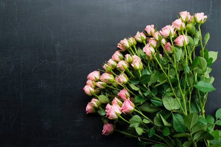 Fresh flowers bush rose on a dark backgroundの写真素材