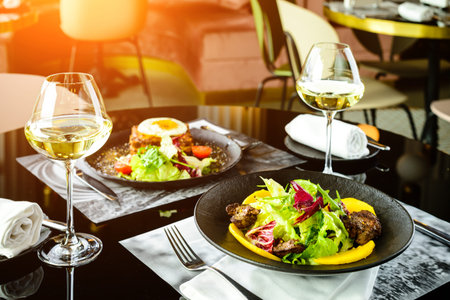 Romantic dinner at a restaurant. Appetizing dishes with meat and