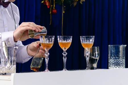 Unidentified barman preparing cocktail at bar counterの写真素材