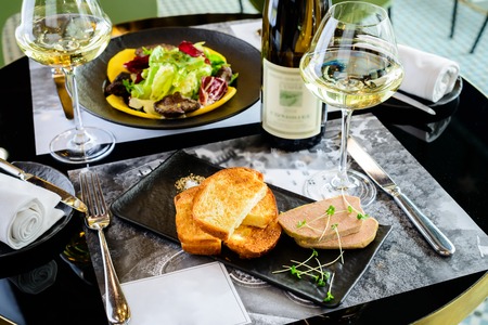 Tasty foie Gras with toasts and glass of white wineの写真素材