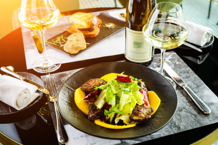 Tasty dish with juicy beef steak and fresh lettuce leaves at a r