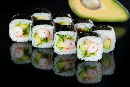 Japanese cuisine. Appetizing maki sushi rolls with rice, avocadoの写真素材
