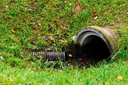 Culvert pipe hole system draining sewage water with little puddle