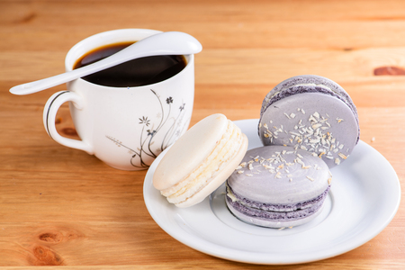 French sweet cookies marshmallows and cup of coffee on the wooden tableの写真素材