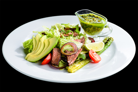 Delicious green meat salad with roasted juicy steak, avocado andの写真素材