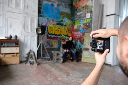 Photographer man makes a family photoの写真素材