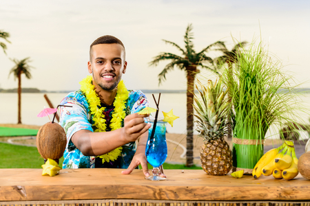 Handsome Latin American bartender standing near the bar counter,の写真素材