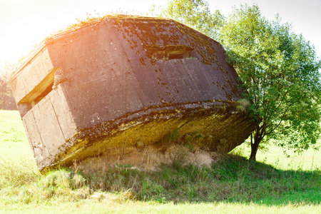 Historically concrete remains of the Second World War at field. Heave of the soil