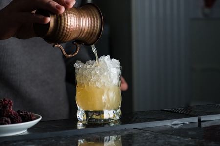 bartender in a nightclub pouring cocktail, bartender at workの写真素材
