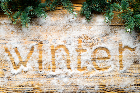 Christmas background. Fir branches on wooden background with written 2018 in the snow. Top view, flatの写真素材
