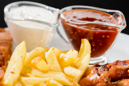 Food background with delicious fried potato and sauces, close-upの写真素材
