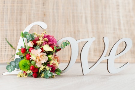 Valentine's day concept with gift box, letters love and flowers on old vintage wooden backgroundの写真素材
