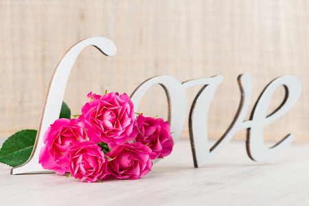 fresh flowers, shrub rose and the words love, a concept for Valentine's Dayの写真素材
