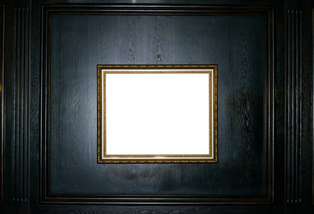 Empty gold frame on a black wooden background copy space