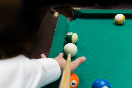 Billiards pool game, athlete with cue close-up