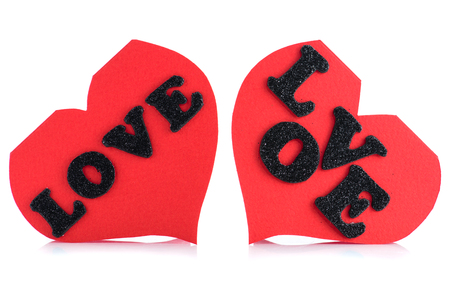 two red greeting cards in the shape of heart with written word love isolated on white backgroundの写真素材