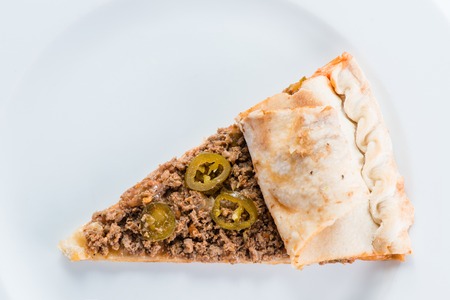 Slice of meat pizza with chicken, beef, minced meat and sweet pepper on plate. Top view, close-upの写真素材