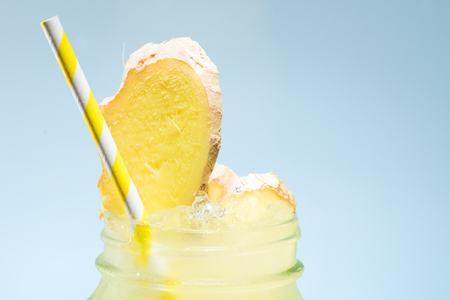 close-up yellow lemonade with slice of gingerの写真素材