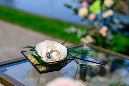 Beautiful glass florarium glass with white rose on the table out