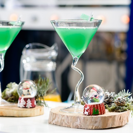 Martini glass with Christmas green cocktail, shallow dofの写真素材