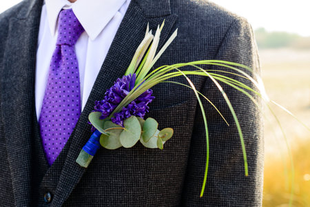 Wedding day. Beautiful creative groom boutonniere on the suit of