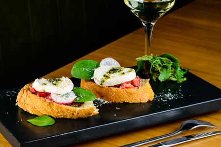 Appetizing sandwiches bruschetta with cottage cheese, radish and mintの写真素材