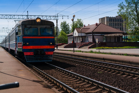 old electric train approaching in the station, symbol of railway travellingの写真素材